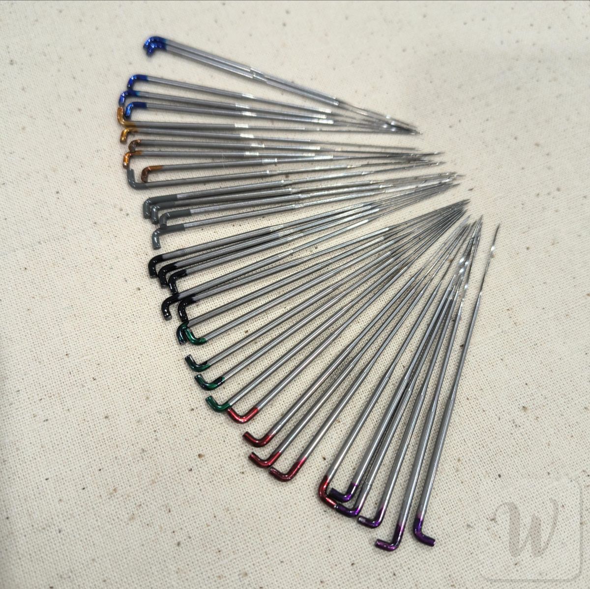 Complete set of 40 colour-coded felting needles including triangular, star, spiral and reverse types in various gauges